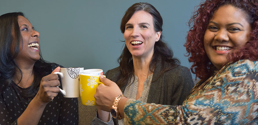 CCRLA co-directors cheersing coffee mugs